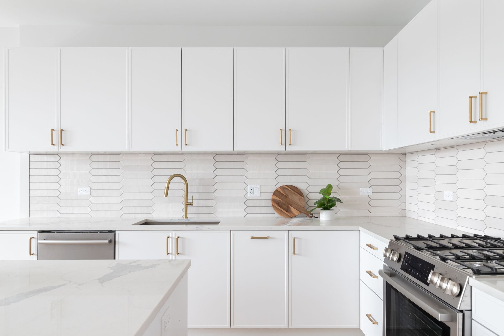 A kitchen with white cabinets and stainless steel appliances.