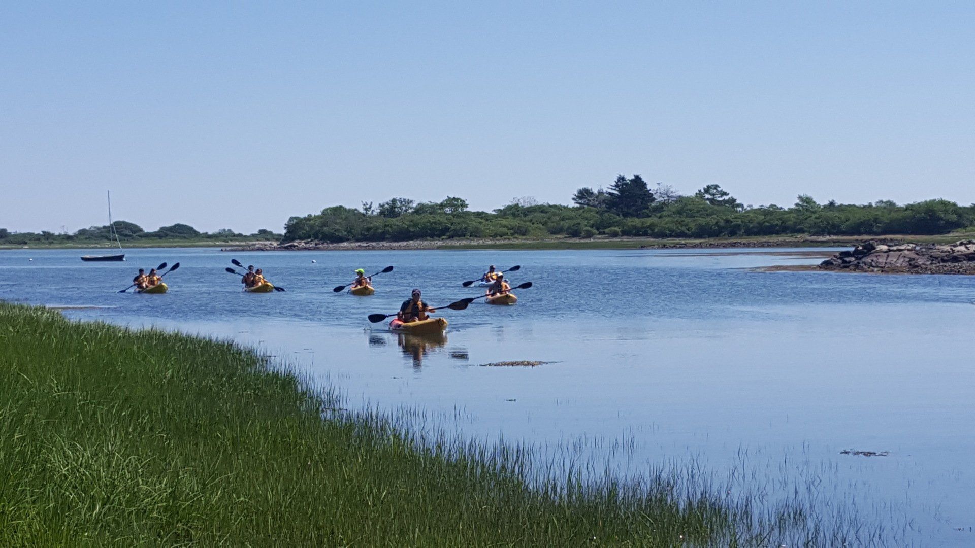 Group of people on kayak passing by the Maine