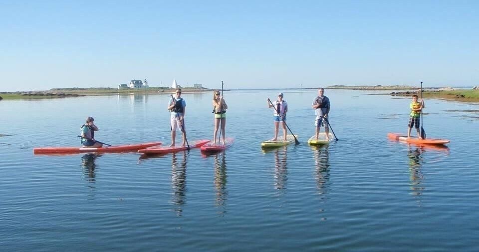 A woman on the kayak in the middle of the Maine
