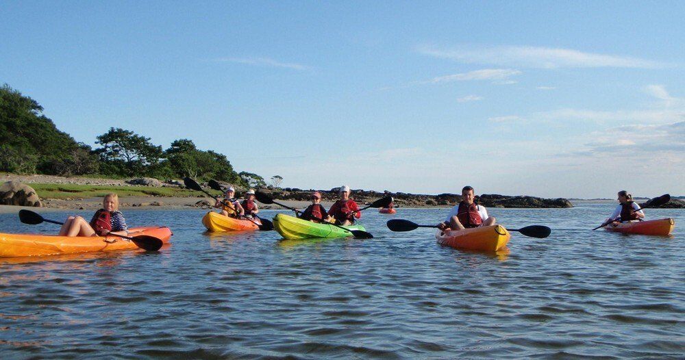 A woman on the kayak in the middle of the Maine