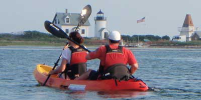 Kayaks, paddles and others things on the land