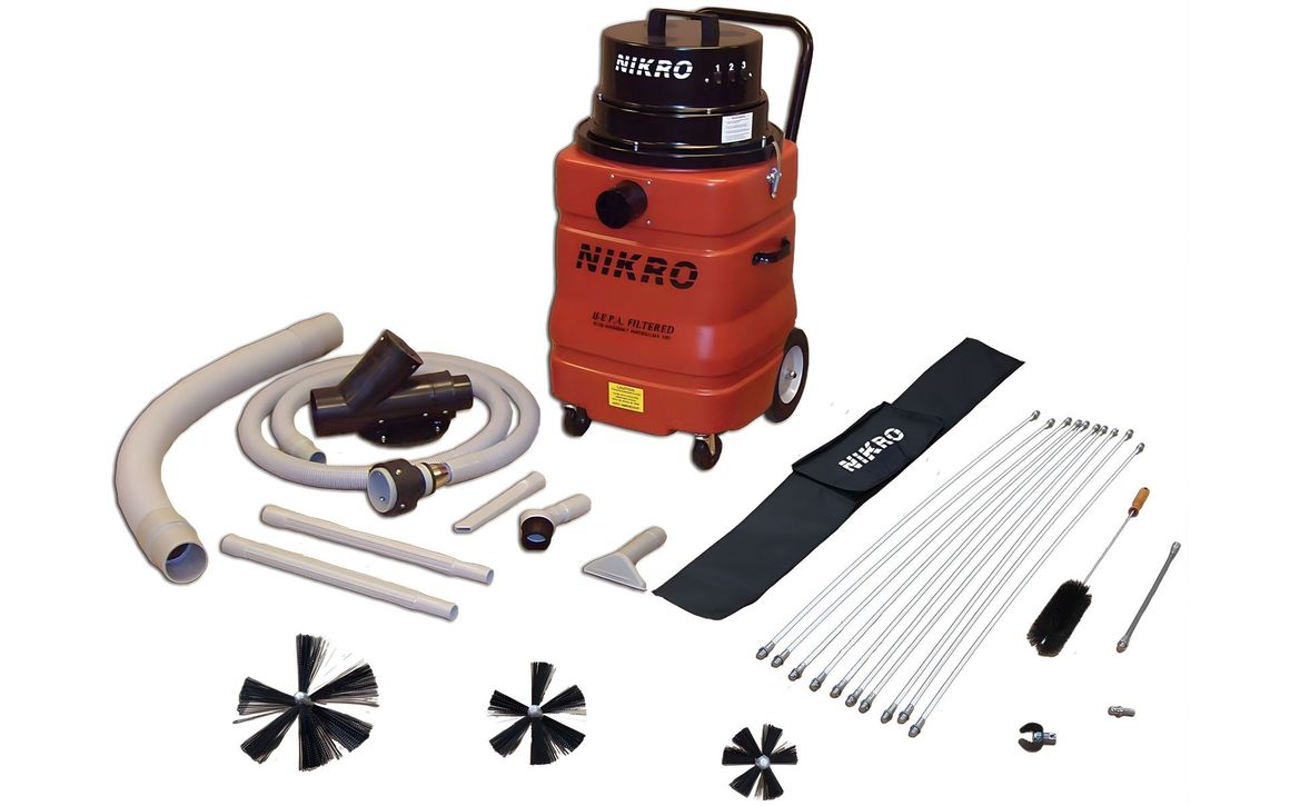 Red KIRRAG compressor with hoses, nozzles, rods, and attachment parts laid out on white background