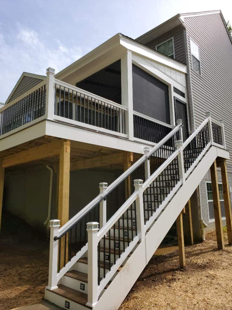 A house with a deck and stairs leading up to it