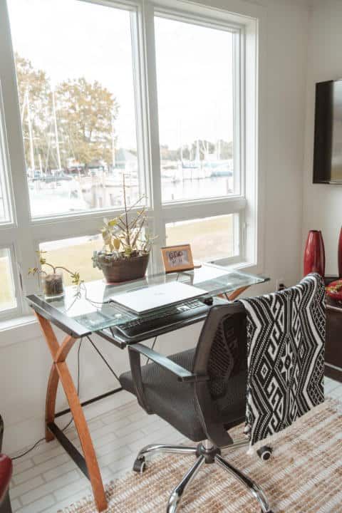 A home office with a desk and chair in front of a window.