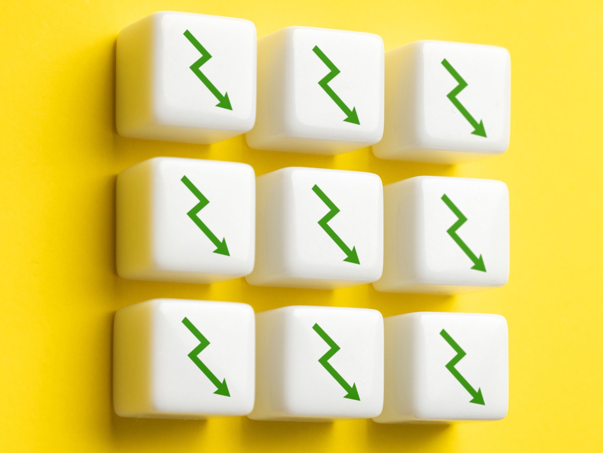 Nine white cubes with green downward zigzag arrows on a yellow background