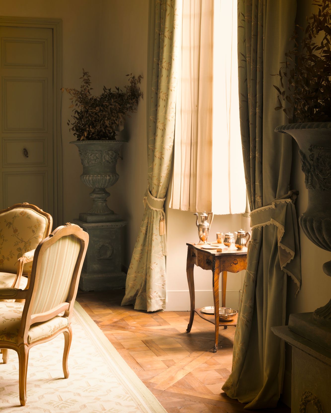 A room with a table and chairs and a window