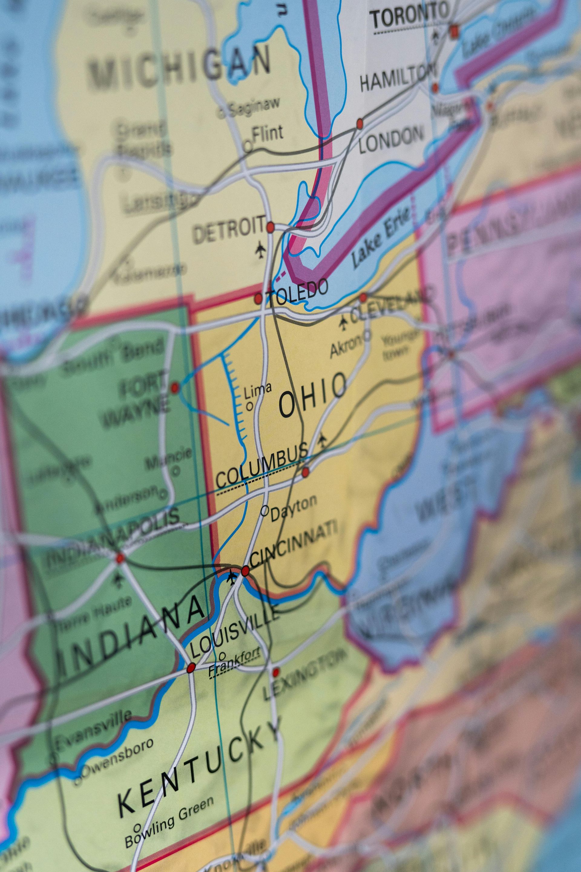 A close-up, angled view of a colorful political map focusing on Ohio, Indiana, Kentucky, and neighboring states.