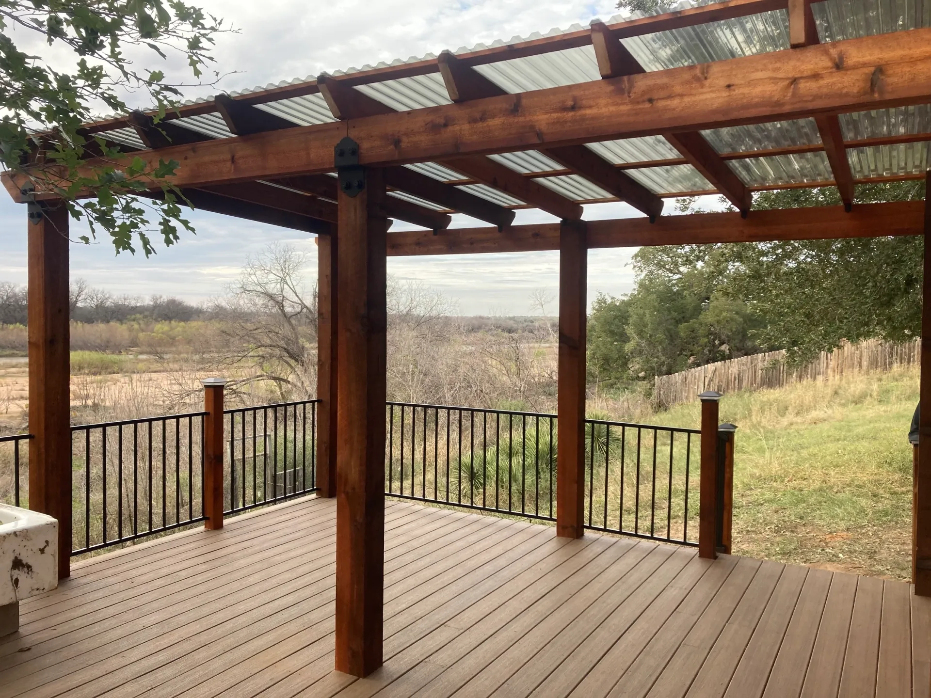 Wooden deck overlooking grassy Hill Country landscape, TTT Construction