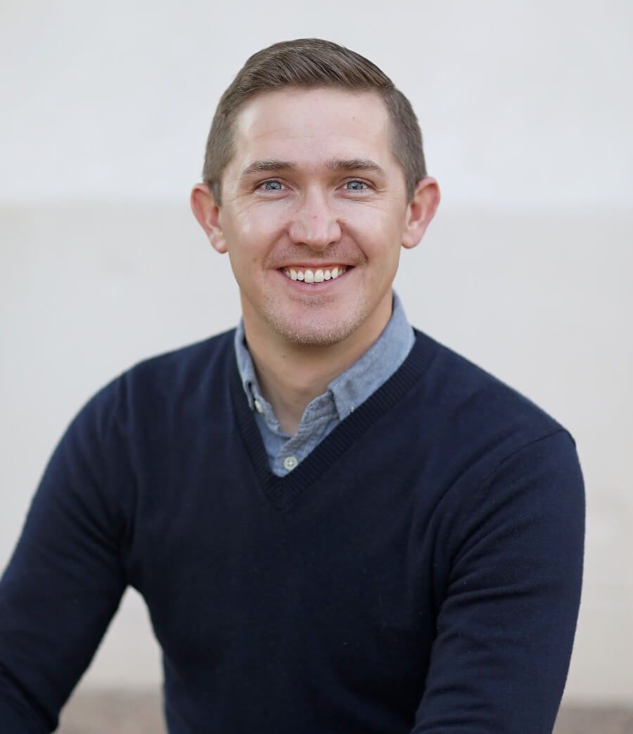 Dr Udall in a navy sweater and blue collared shirt against a light background