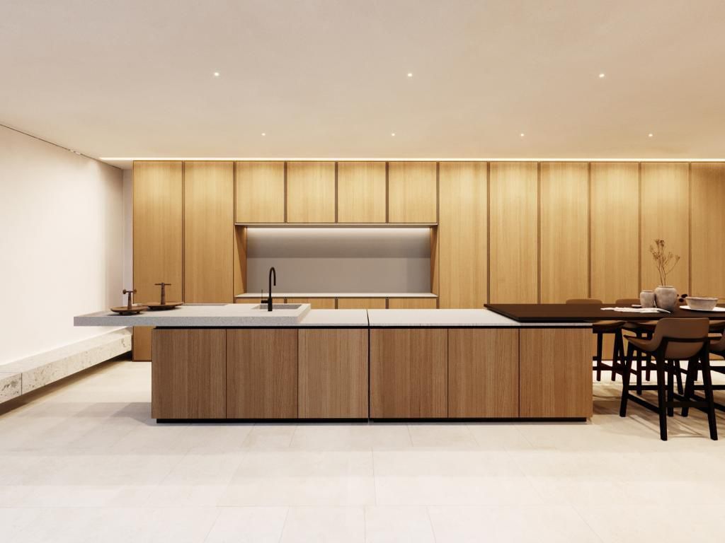 Cucina lussuosa: isola in legno scuro con piano in marmo, porta ad arco, pareti in terracotta, vista sull'oceano.