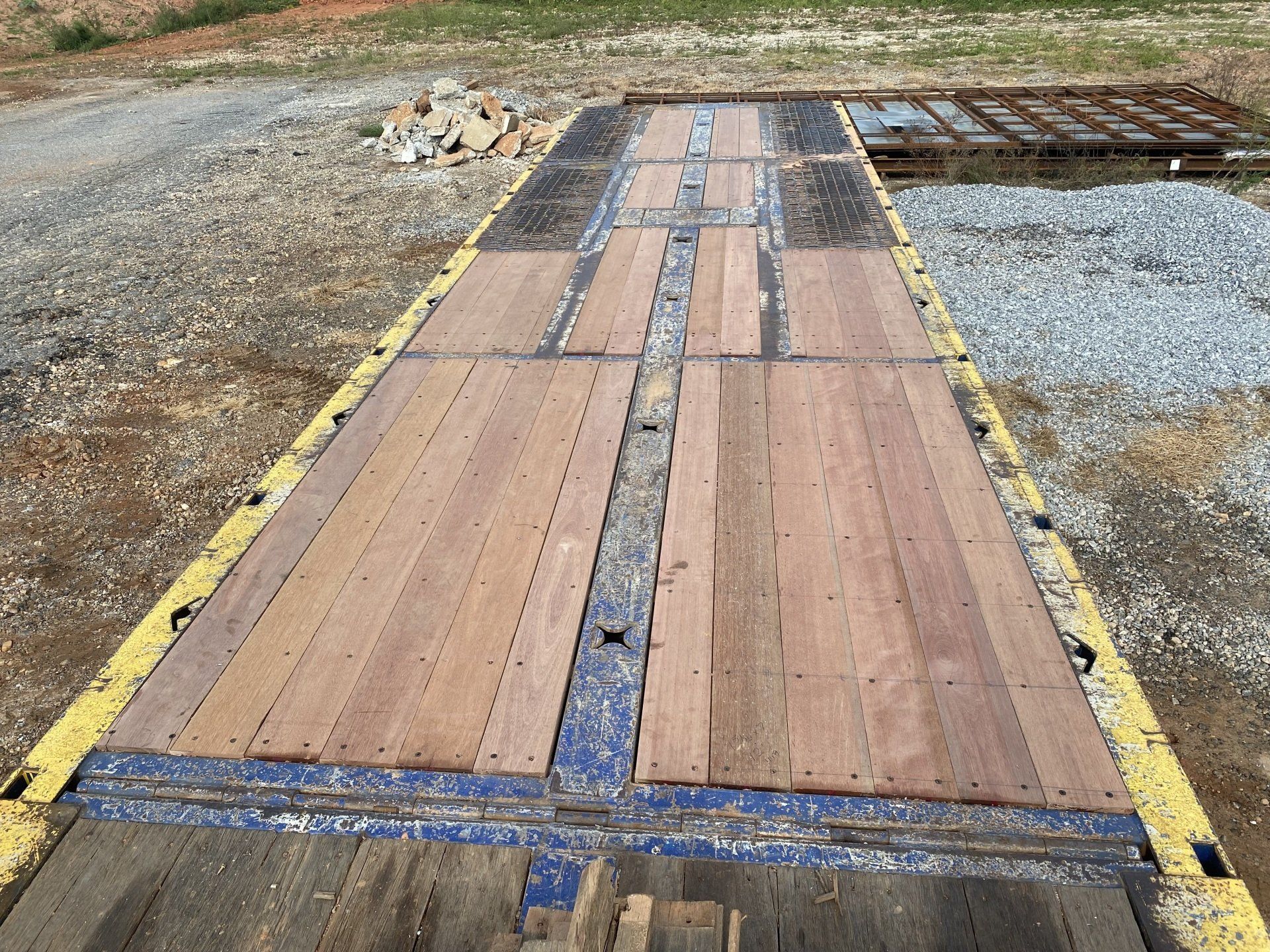 A large wooden platform with a yellow stripe on the side