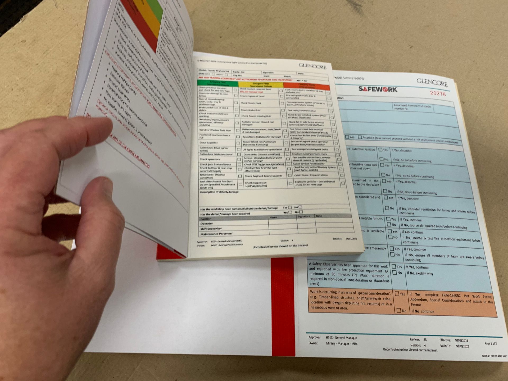 A Hand Holding Open A Permit Book  — Steejo Press in The Gap, QLD