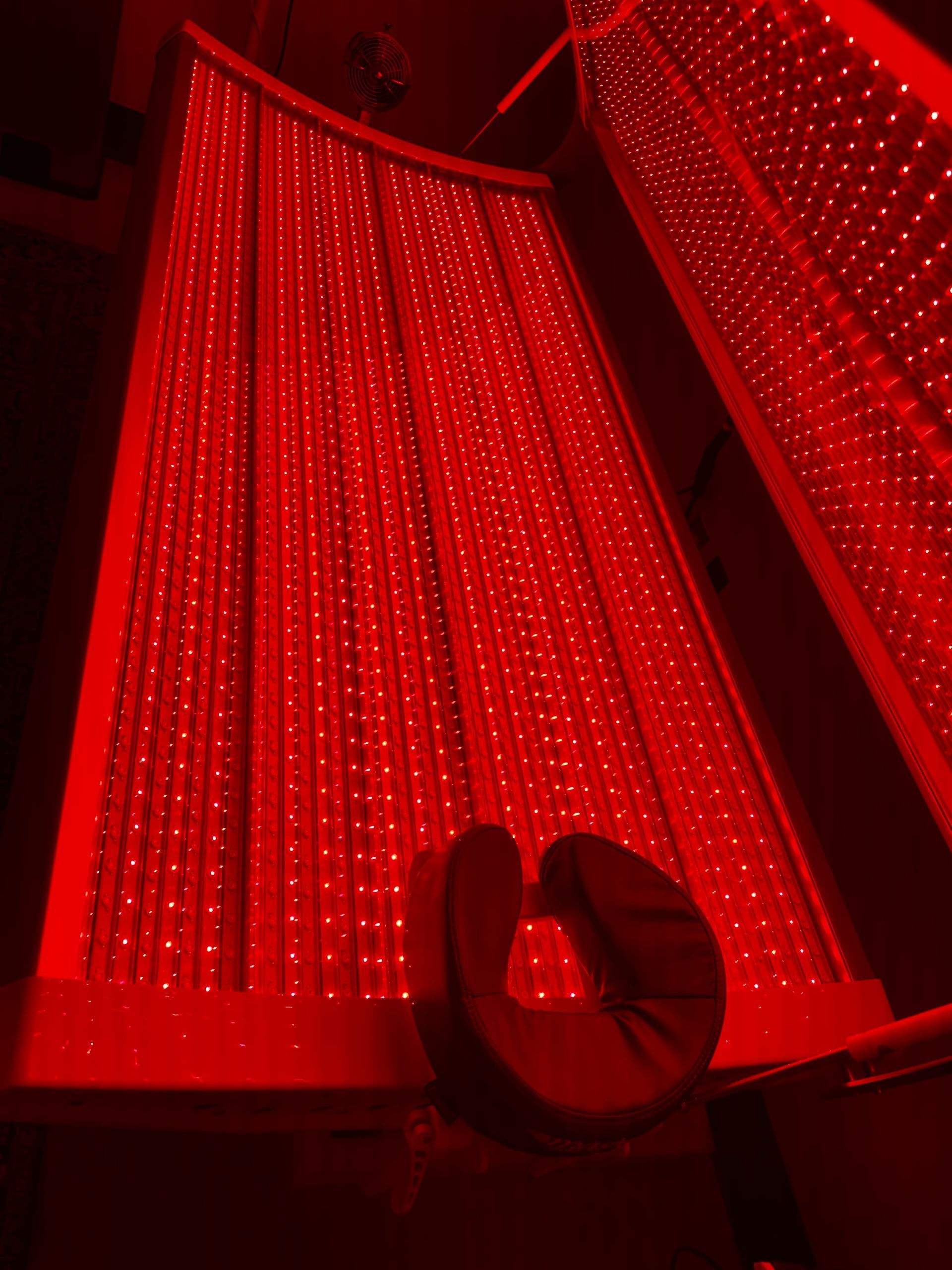 Red-lit draped curtains with a couple silhouette in the foreground, creating a dramatic stage-like scene