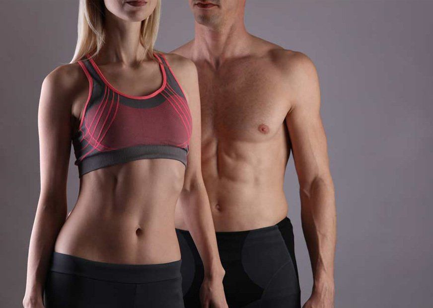 A man and a woman without shirts are standing next to each other.