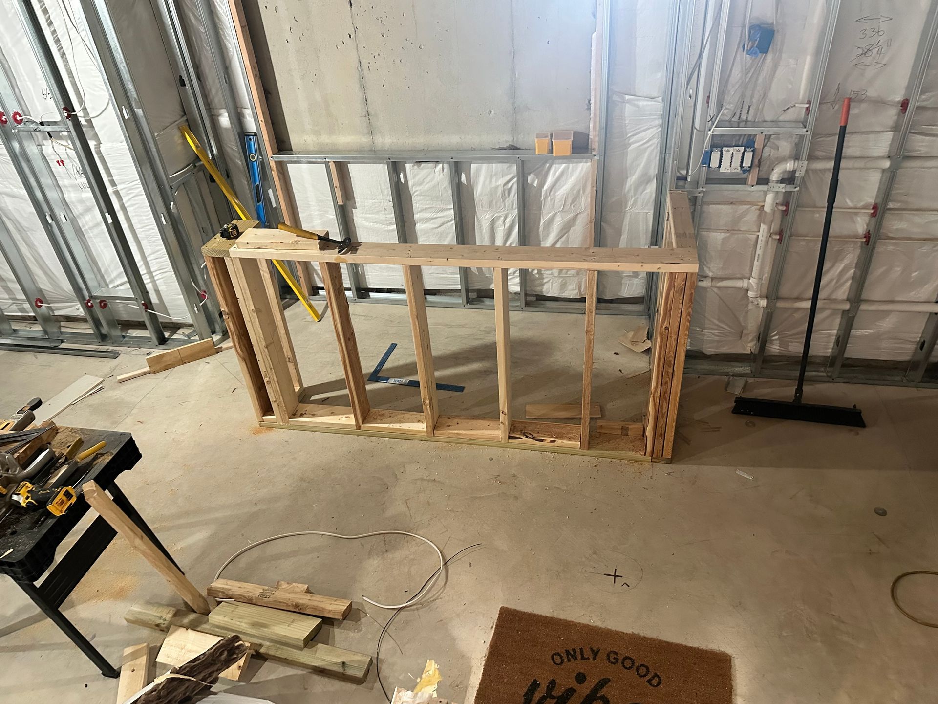 Renovation in progress with exposed framing and unfinished interior walls