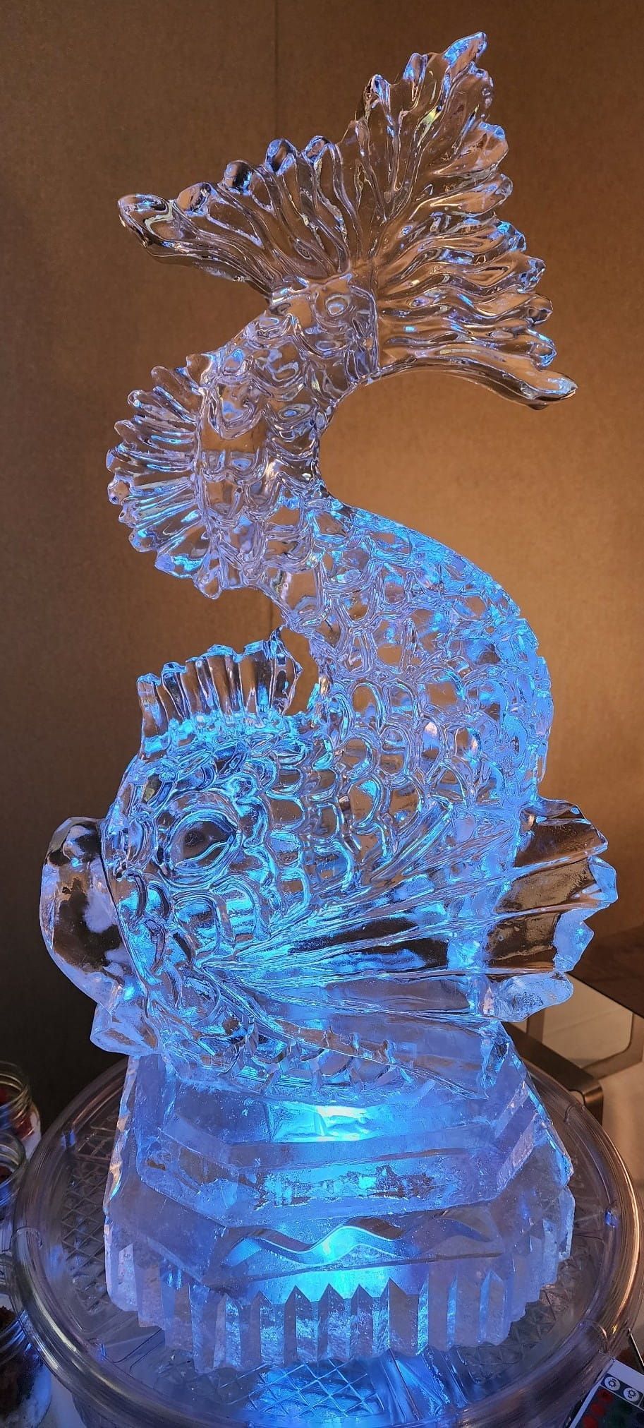 Blue-lit crystal seahorse sculpture on a glowing base