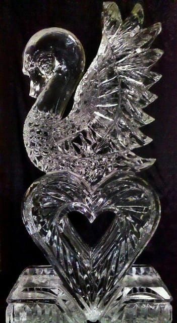 Crystal swan with a heart-shaped body on a black background