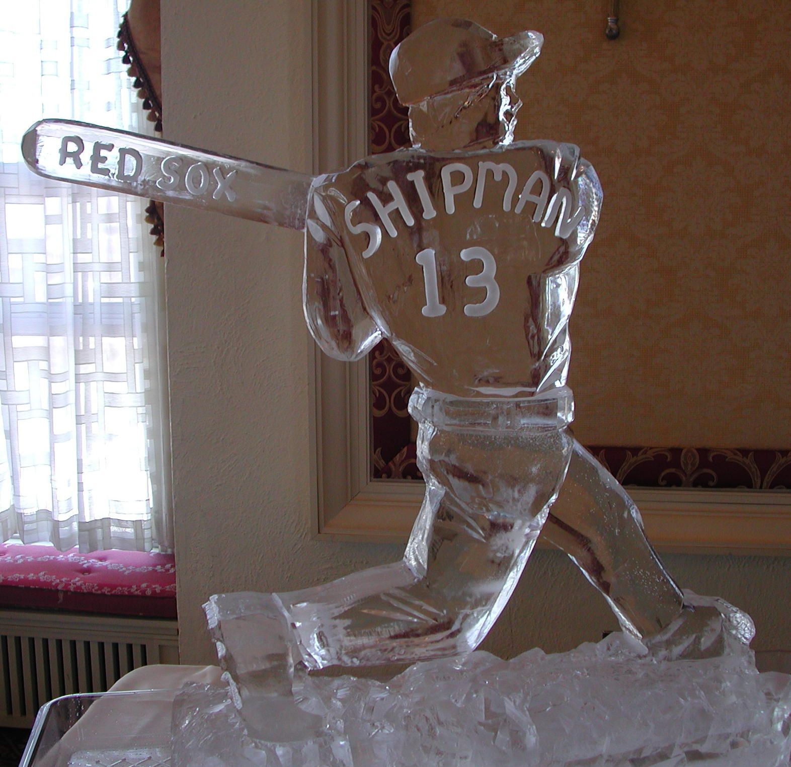 Ice sculpture of a hockey player wearing jersey number 13, with “Red…” on the arm and “Strip…” on the back.