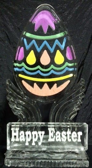 Colorful Easter egg decoration with a “Happy Easter” sign on a black background