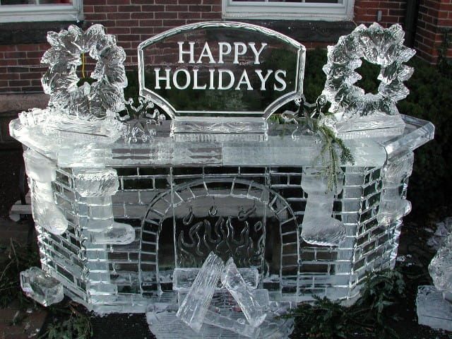 Icy holiday fireplace decoration with wreaths and a “Happy Holidays” sign
