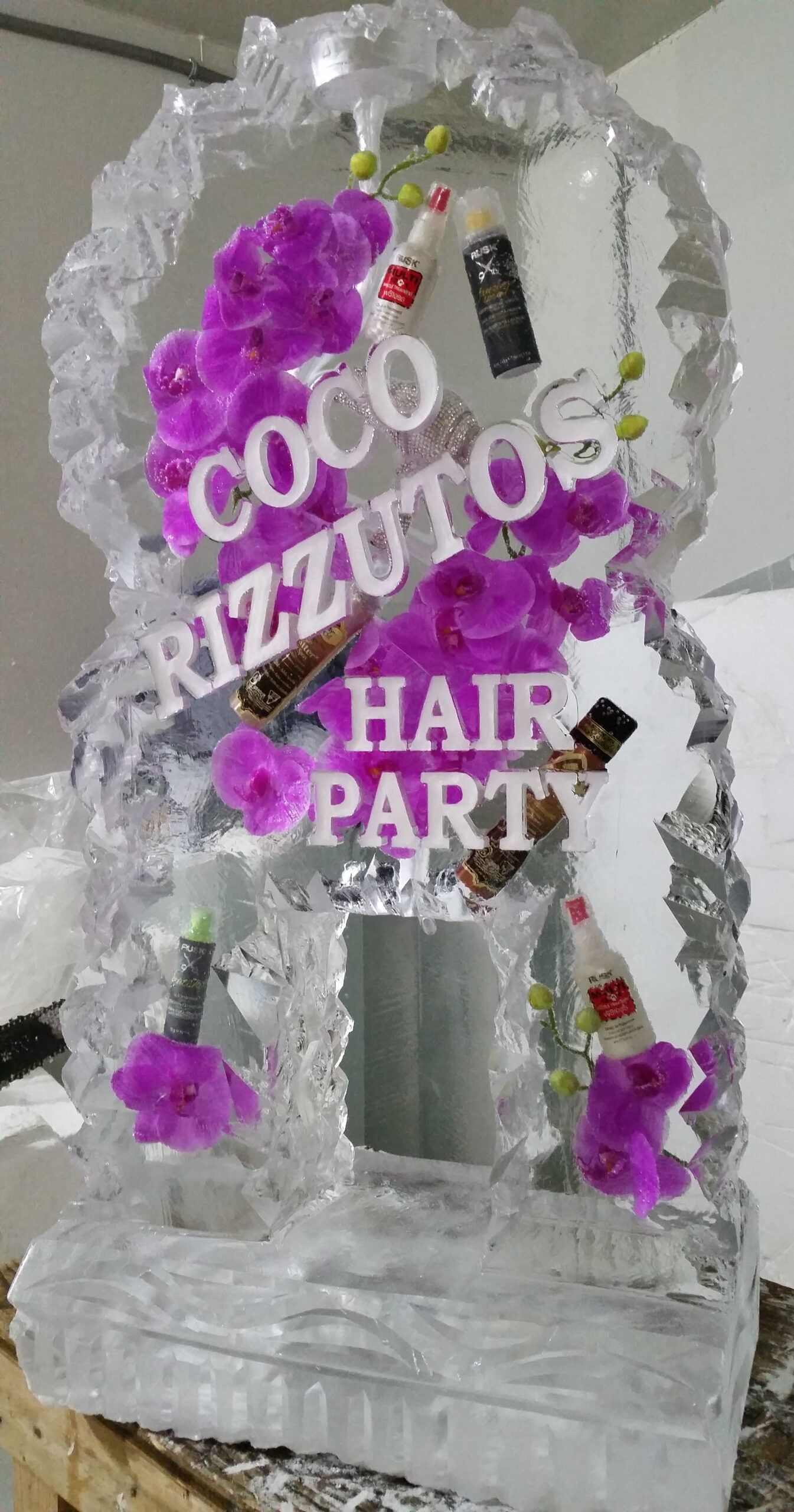 White-and-purple decorative tower with “COCO” and “HAIR PARTY” text, on a silver base