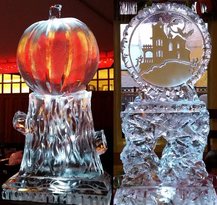 Two clear ice sculptures: a glowing pumpkin and a haunted house scene against a red-lit background