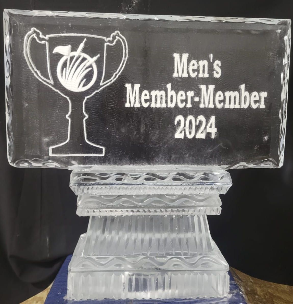 Clear trophy plaque reading “Men’s Member-Member 2024” on a crystal base