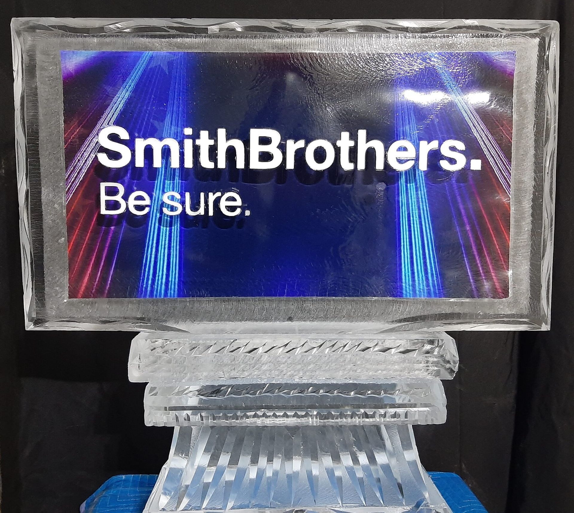 SmithBrothers. Be sure. on a reflective blue and purple sign