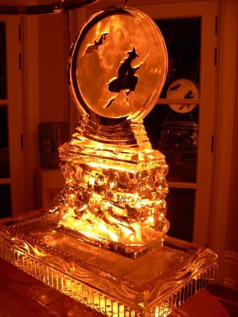 Glowing amber glass trophy or ornament on a table in a dim room