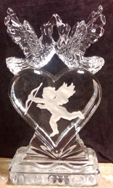 Clear glass heart-shaped angel figurine with wings on a base