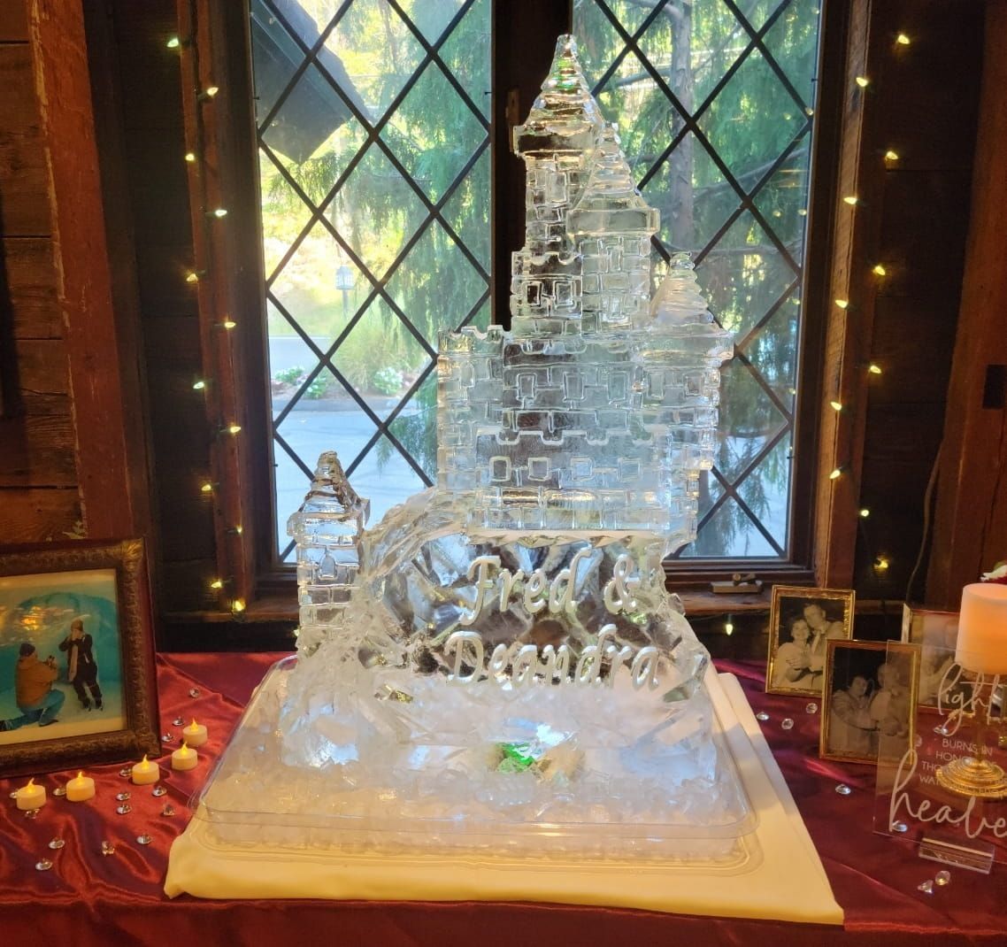 Ice sculpture of a castle on a table in front of a window with diamond panes and warm candlelight.