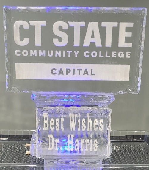 CT State Community College Capital sign above a small “Best wishes Dr. Harris” plaque