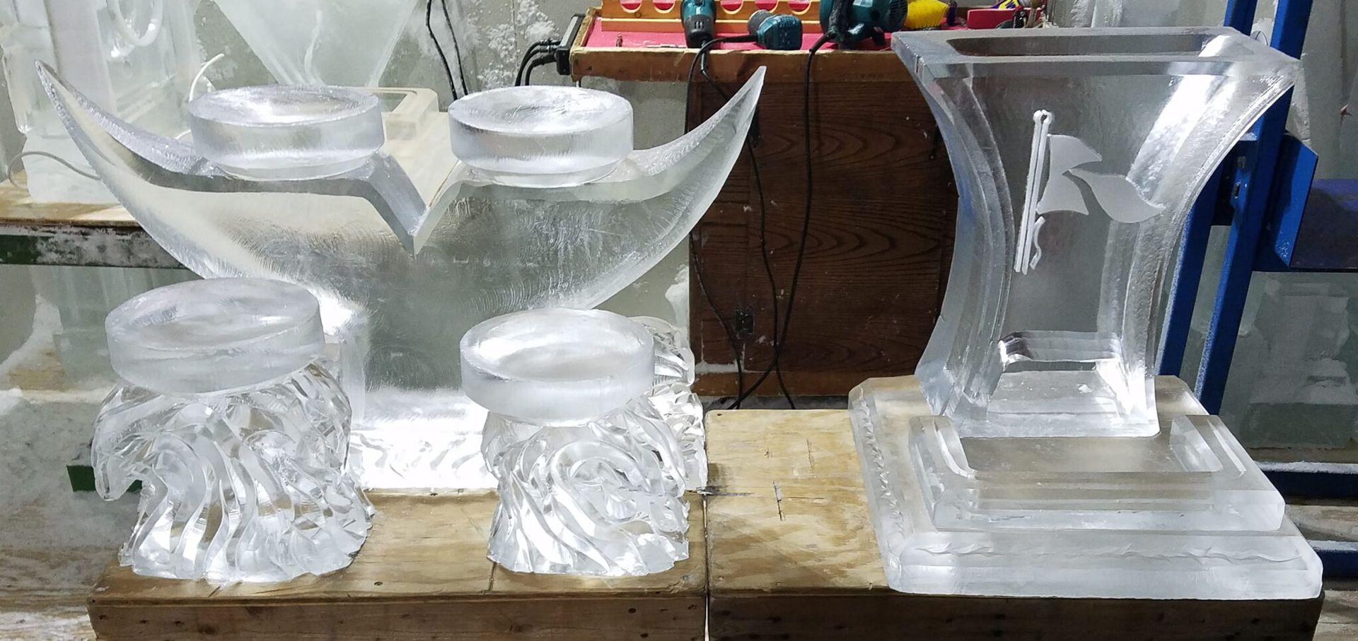 Decorative clear glass candle holders and vases displayed on a wooden surface