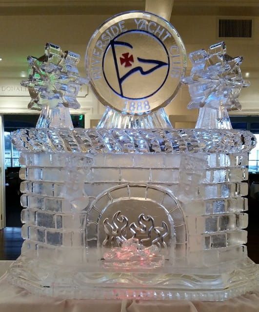 Clear ice sculpture with a circular emblem and star centerpiece displayed indoors.