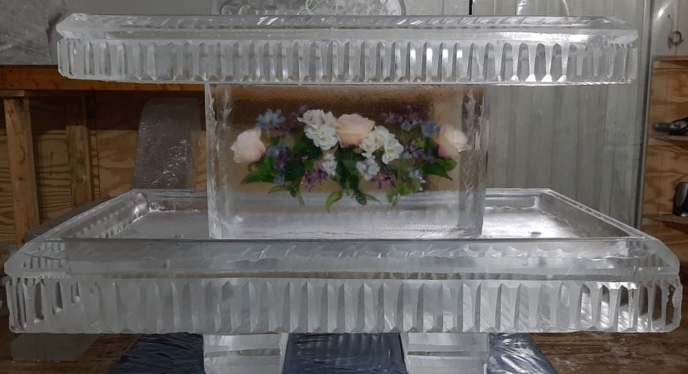 Clear plastic decorative display case with a small floral arrangement inside