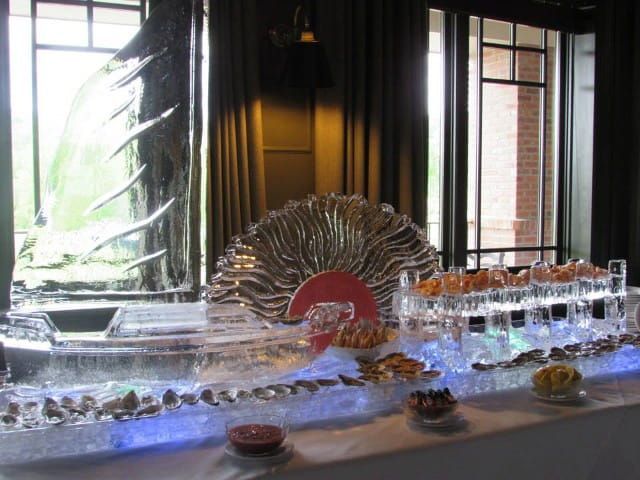 Decorative tabletop fountain with water flowing over glass and a sunburst centerpiece in a dim room