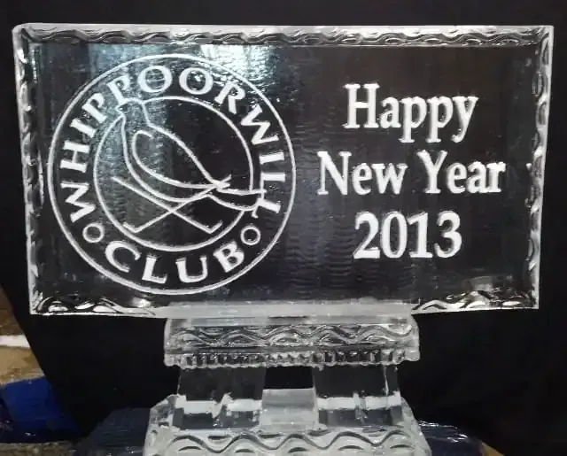 Clear ice plaque with Whippoorwill Club logo and “Happy New Year 2013” text