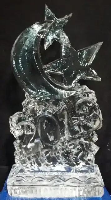Clear glass dolphin sculpture with star accents on a decorative base