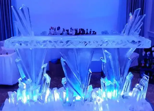 Blue-lit crystal display with an illuminated shelf and decorative pointed glass pieces below
