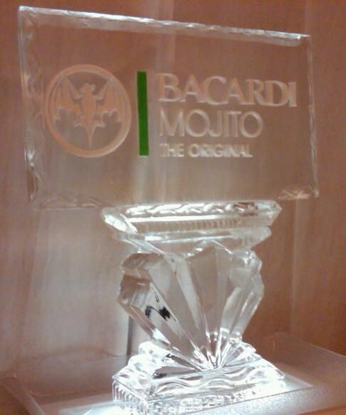 Clear Bacardi Mojito glass trophy on a white base, with green and white branding against a brown background