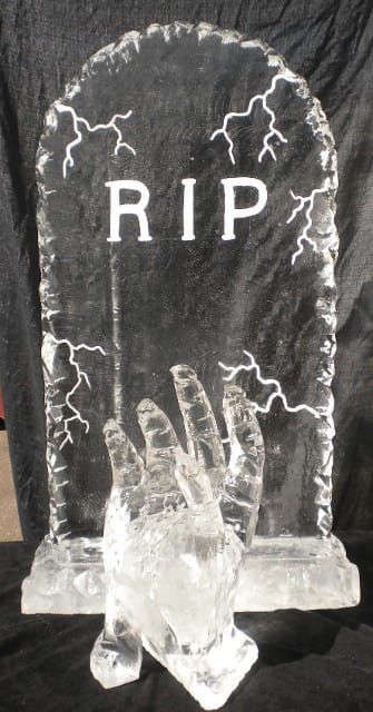 Clear crystal tombstone with “RIP” and lightning-like etching on a black background