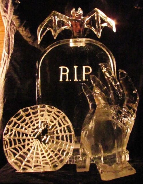 Glass Halloween decoration with bat, hand, web, and “R.I.P.” tombstone