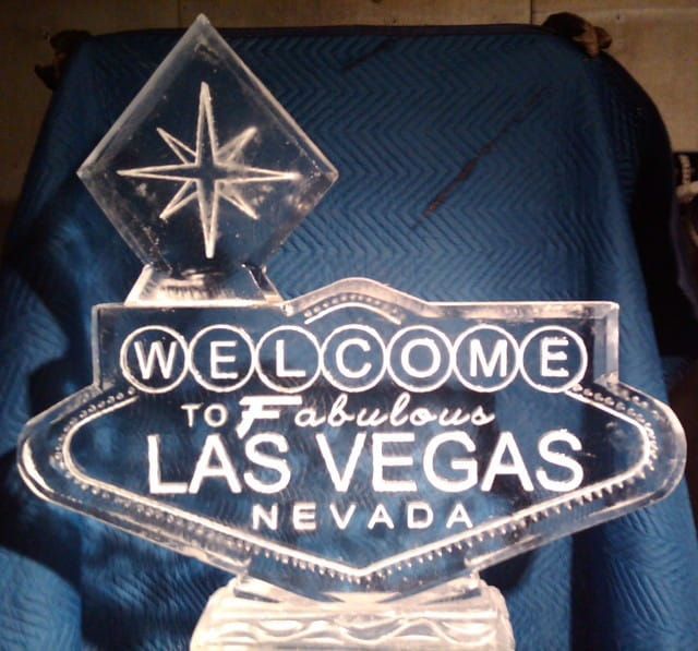 Vintage Las Vegas welcome sign in blue and white, with a starburst on top.