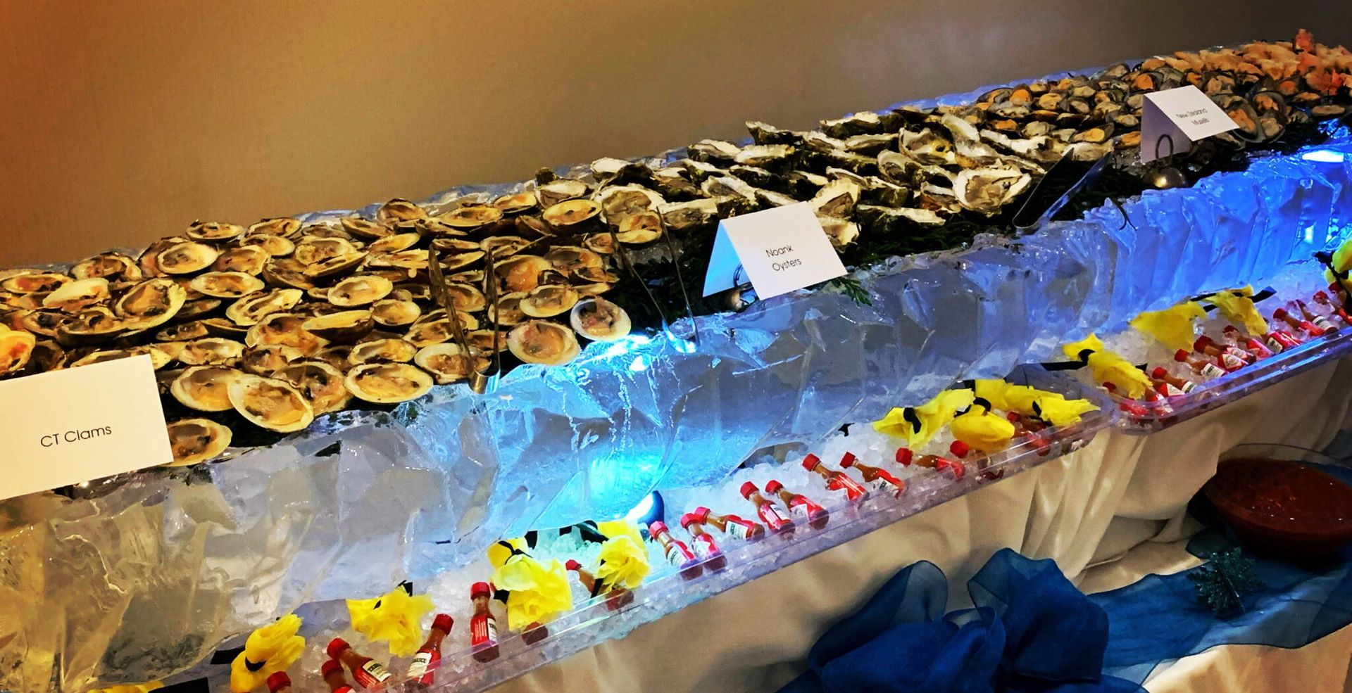 Desserts topped with gold coins on an icy blue display, with colorful treats lined along the front.