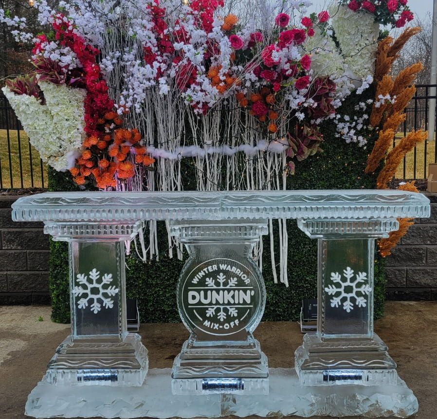 Frozen floral Dunkin’ display with an icy table and snowflake pillars outdoors