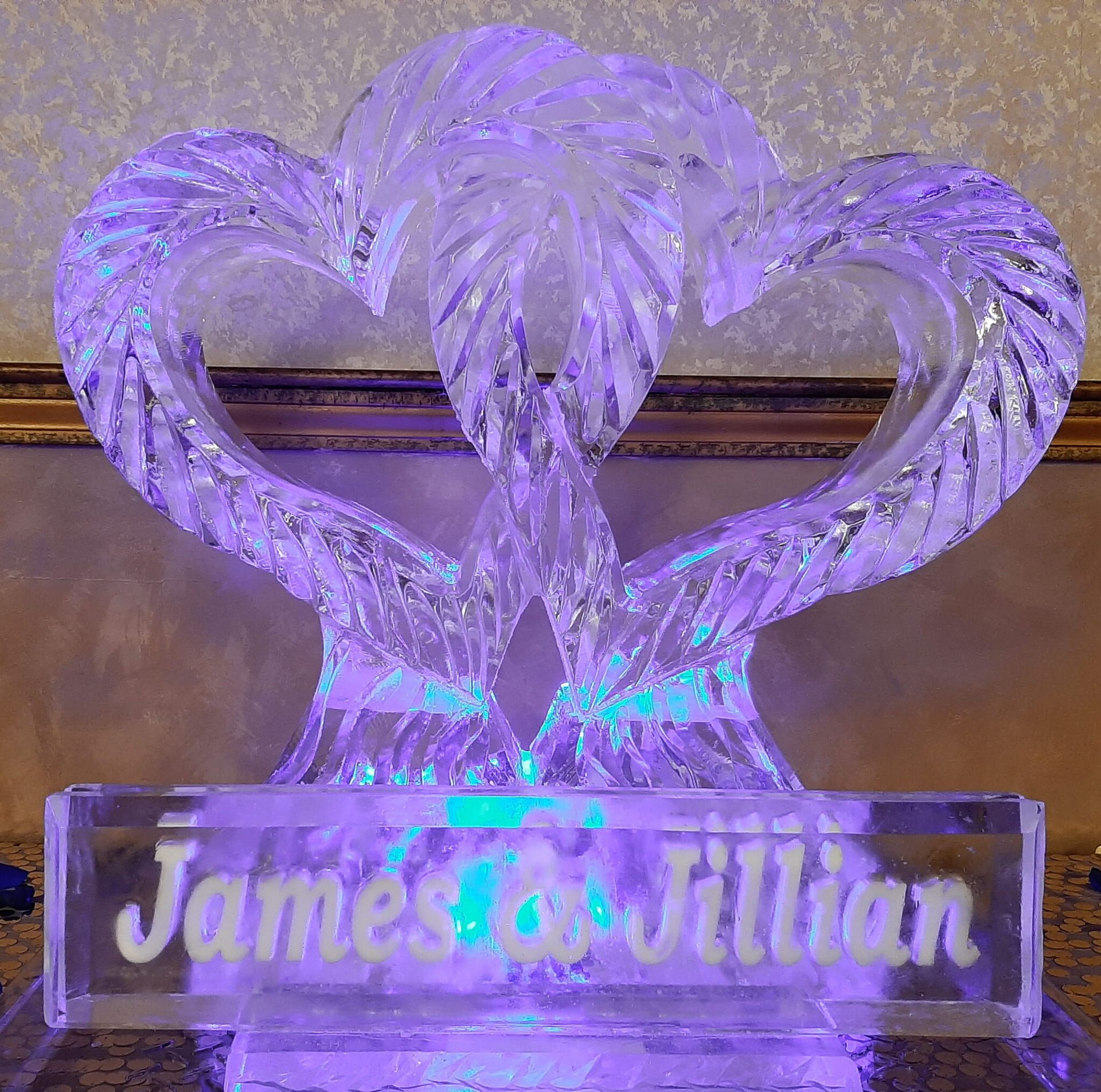 Glowing purple heart-shaped crystal display with “James & Jillian” on a base
