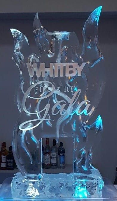 Glowing blue ice sculpture with the word “WHITBY” and “Gala” carved into it.