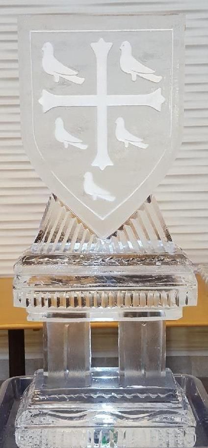 Transparent trophy with a shield emblem and white birds on a clear pedestal.