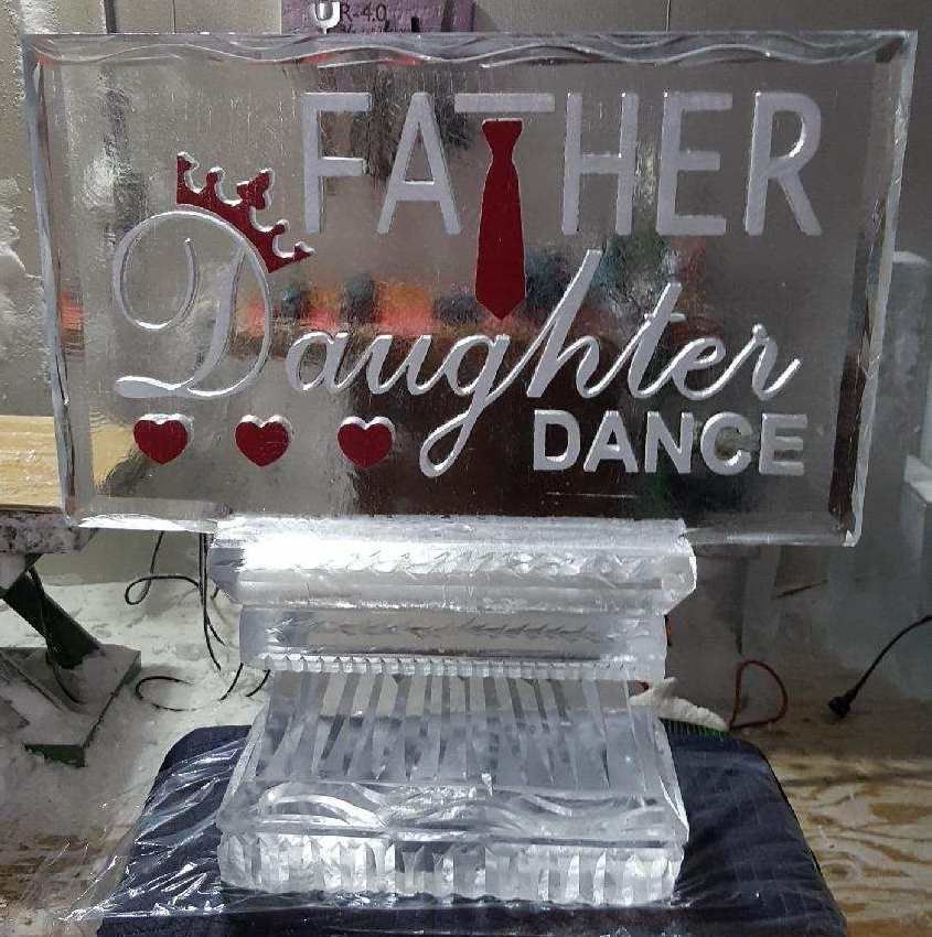 Clear acrylic plaque engraved “Father Daughter Dance” with red hearts and tie on a crystal base.