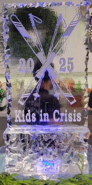 Glass plaque with purple roses and “2025 Kids in Crisis” text over a white butterfly and ribbon design